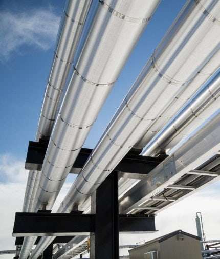Industrial piping against the sky