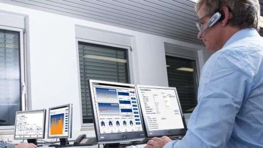 Mies, jolla on kuulokkeet, työskentelee tietokoneiden parissa