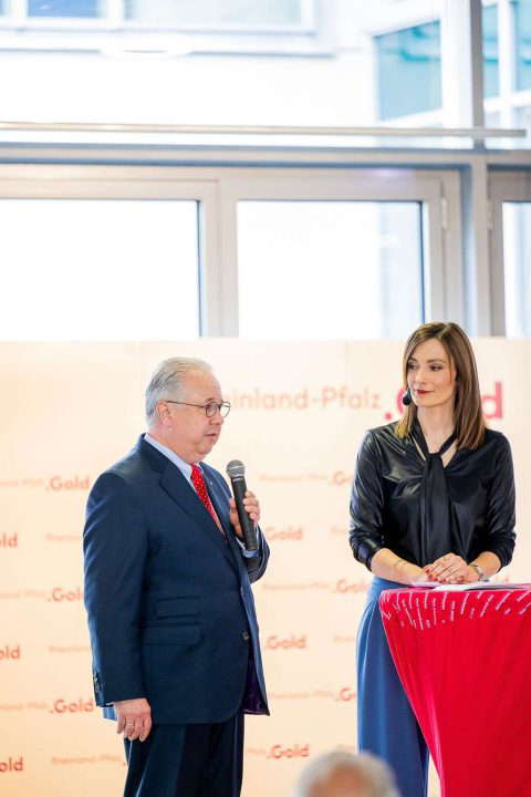 Man speaks with a microphone at an event.