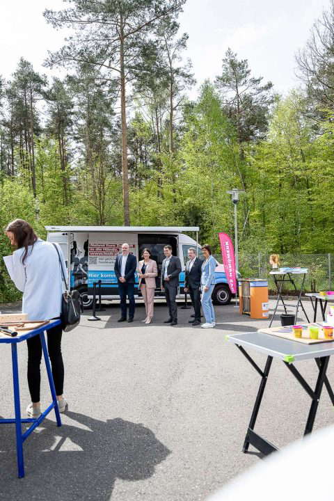 People at an outdoor event in the forest