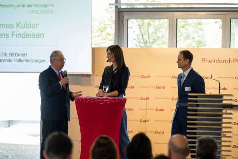 Three people at the award ceremony.