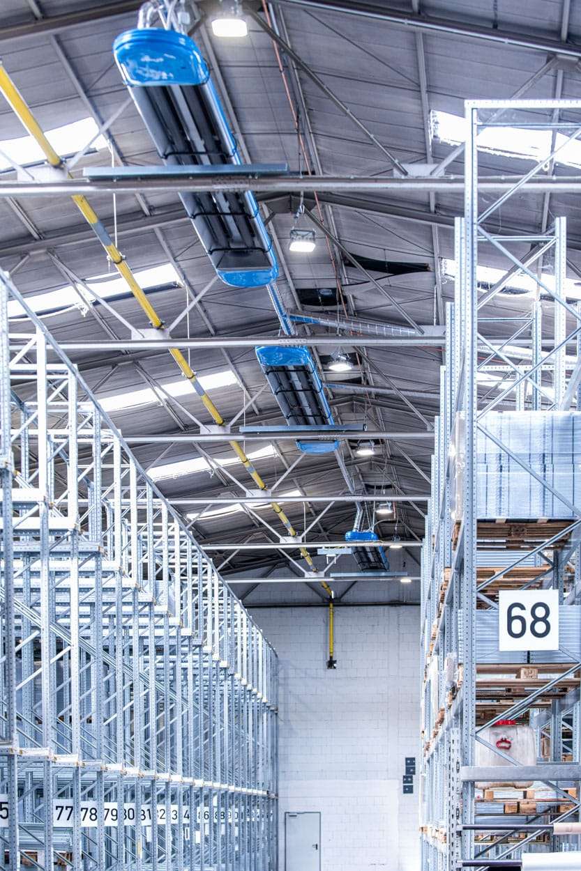 Warehouse with high racks and conveyor system.