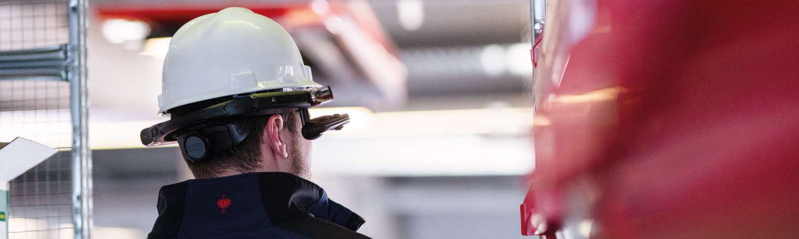 Ingenieur mit Helm bei Überwachungsaufgaben