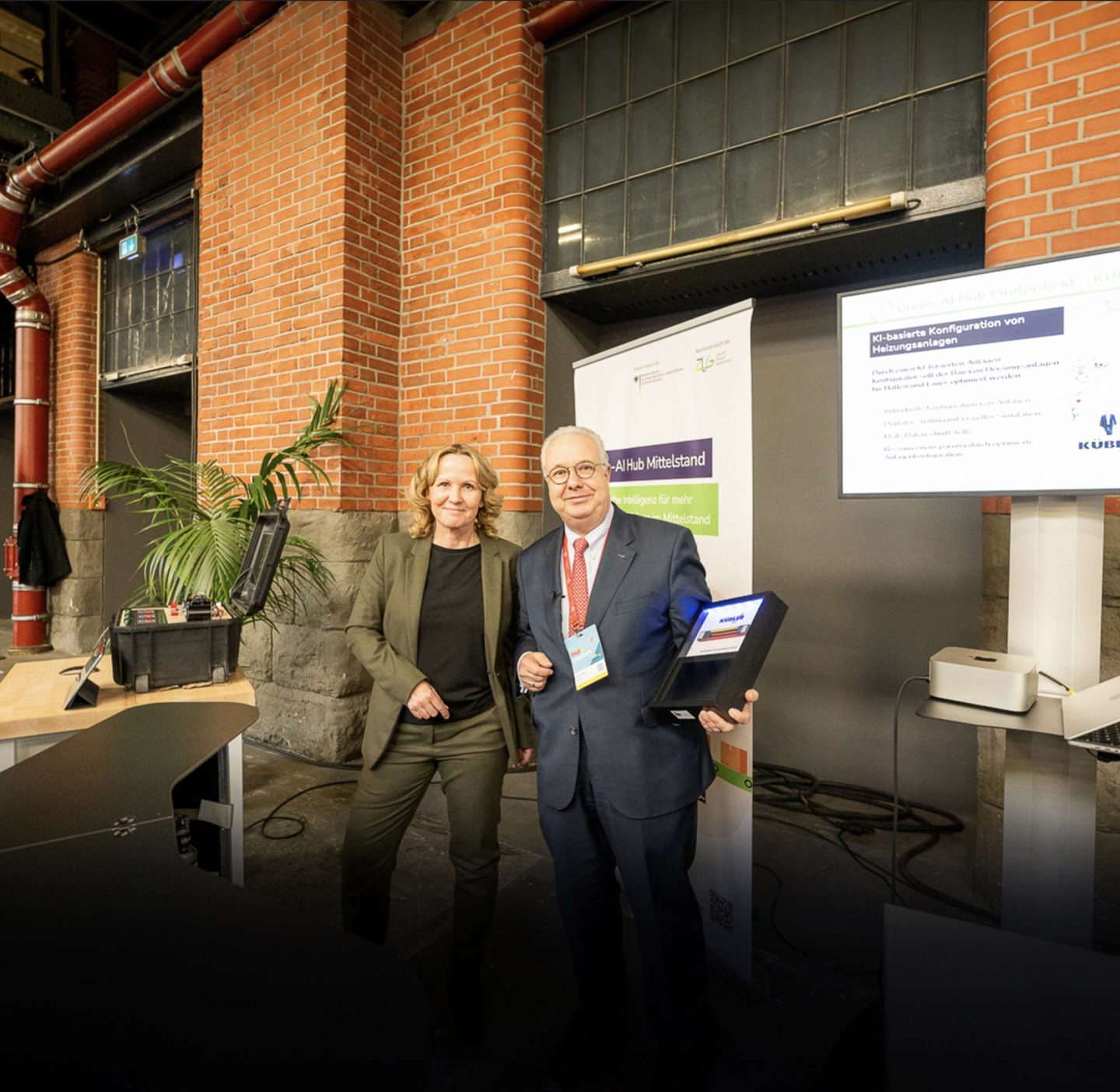 Two people presenting at a conference.